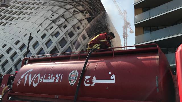 A firefighter participates in efforts to put out a fire that broke out in a building in Central Beirut
