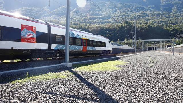 Train stands in front of the entrances of the newly built Ceneri Base Tunnel near Camorino