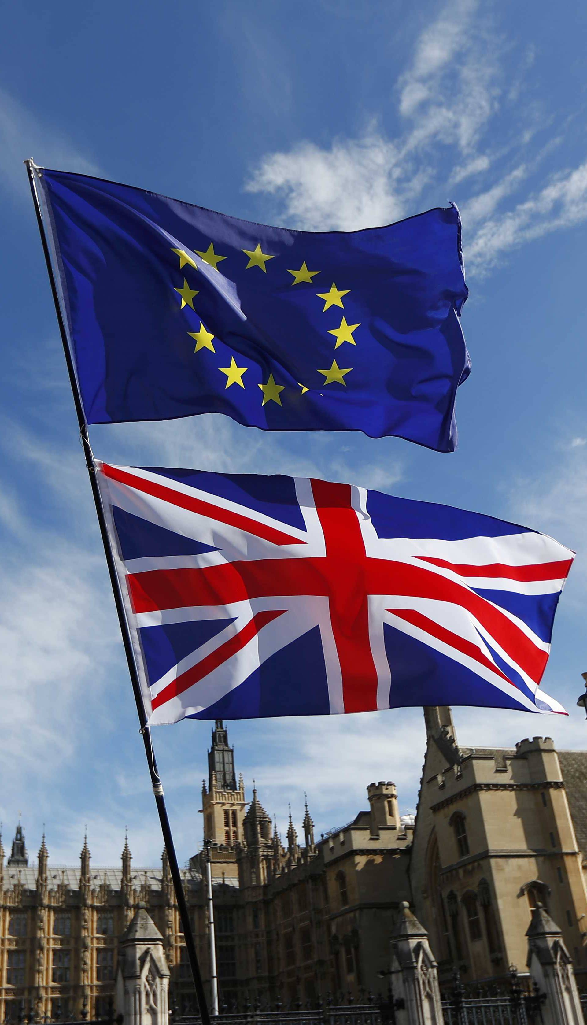 EU and Union flags fly above Parliament Square during a Unite for Europe march, in central London
