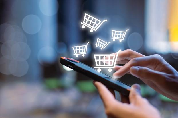 Woman,Using,Smartphone,Shopping,Online,,Shopping,Cart,Icon,On,Screen