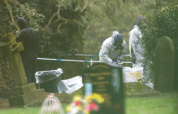 Members of the emergency services wear protective suits at the site of the grave of Luidmila Skripal, wife of former Russian inteligence officer Sergei Skripal, at London Road Cemetery in Salisbury