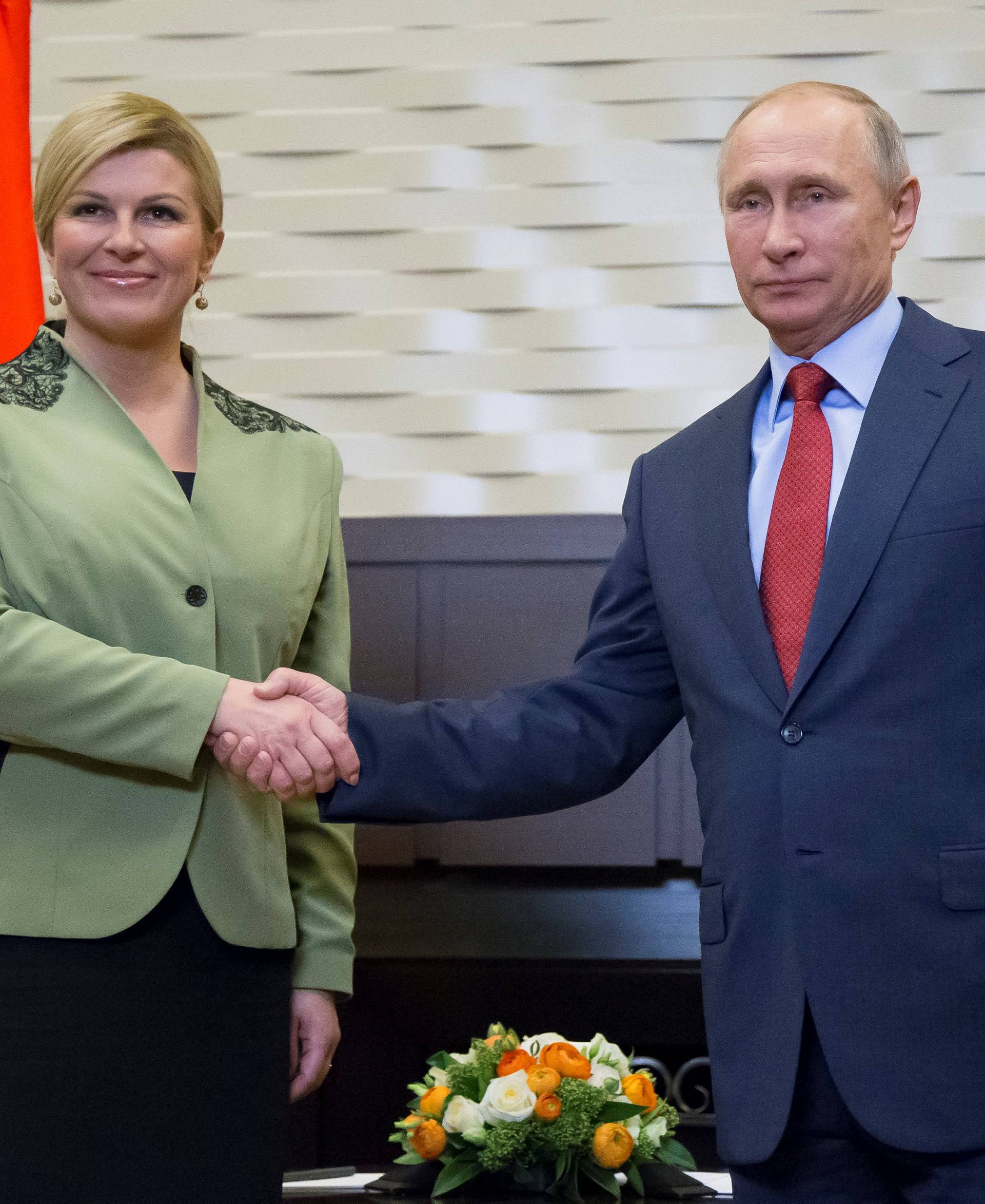 Putin shakes hands with Croatian President Kolinda Grabar-Kitarovic during their meeting in Sochi