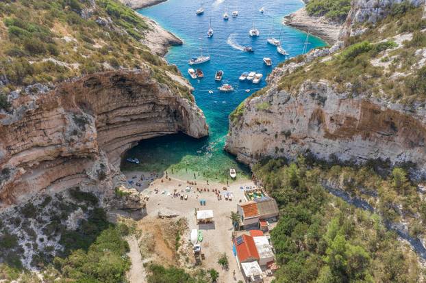 Aerial drone shot of iconic Stiniva cove beach of Adriatic sea on Vis Island in Croatia summer