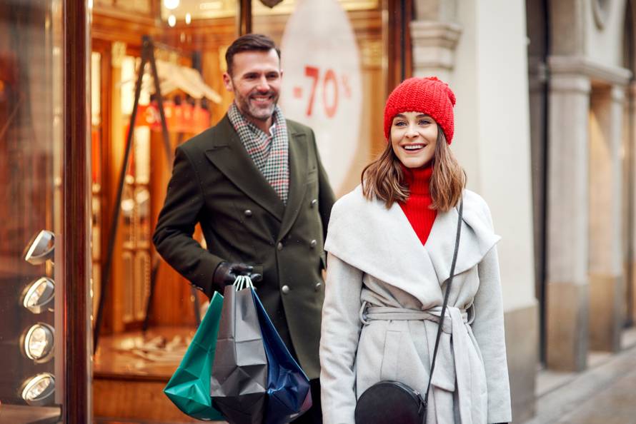 Cheerful couple during Christmas shopping 
