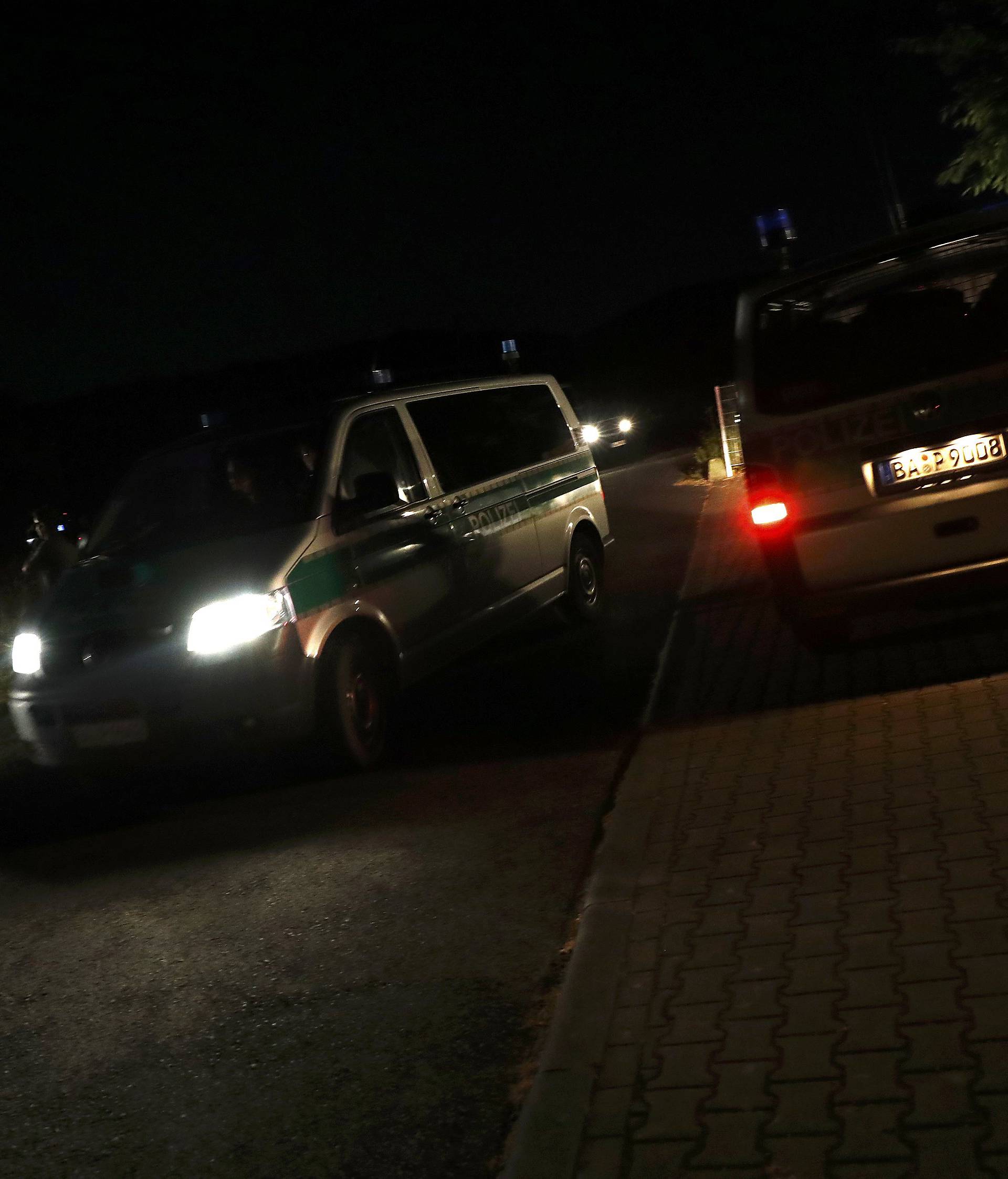 German police cars move at the scene where a man with an axe attacked passengers on a train near the city of Wuerzburg