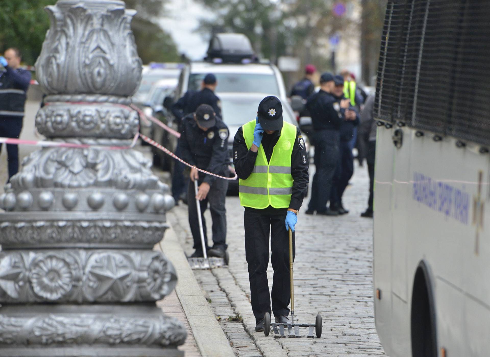 Investigators and policemen work at the site of an explosion in Kiev