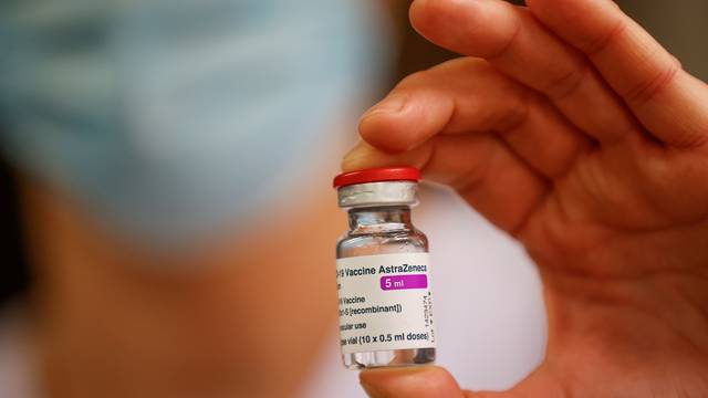 A member of the medical staff holds a vial of the AstraZeneca-Oxford COVID-19 vaccine, in Melun