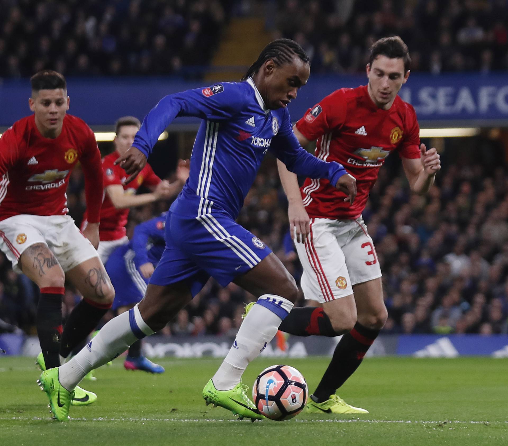 Chelsea's Willian in action with Manchester United's Matteo Darmian and Marcos Rojo