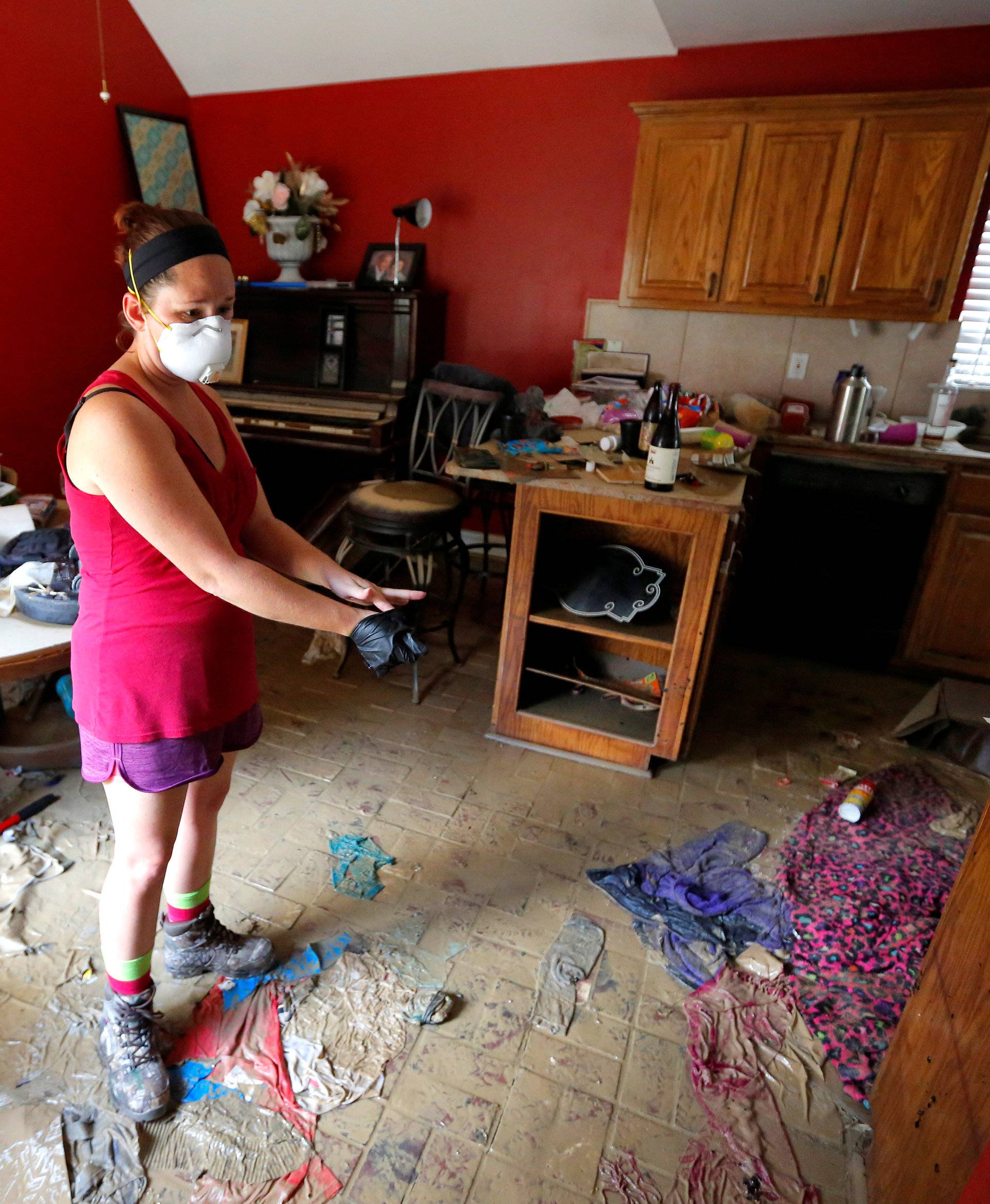 Johnette Folse stands in her flood damaged kitchen in Denham Springs