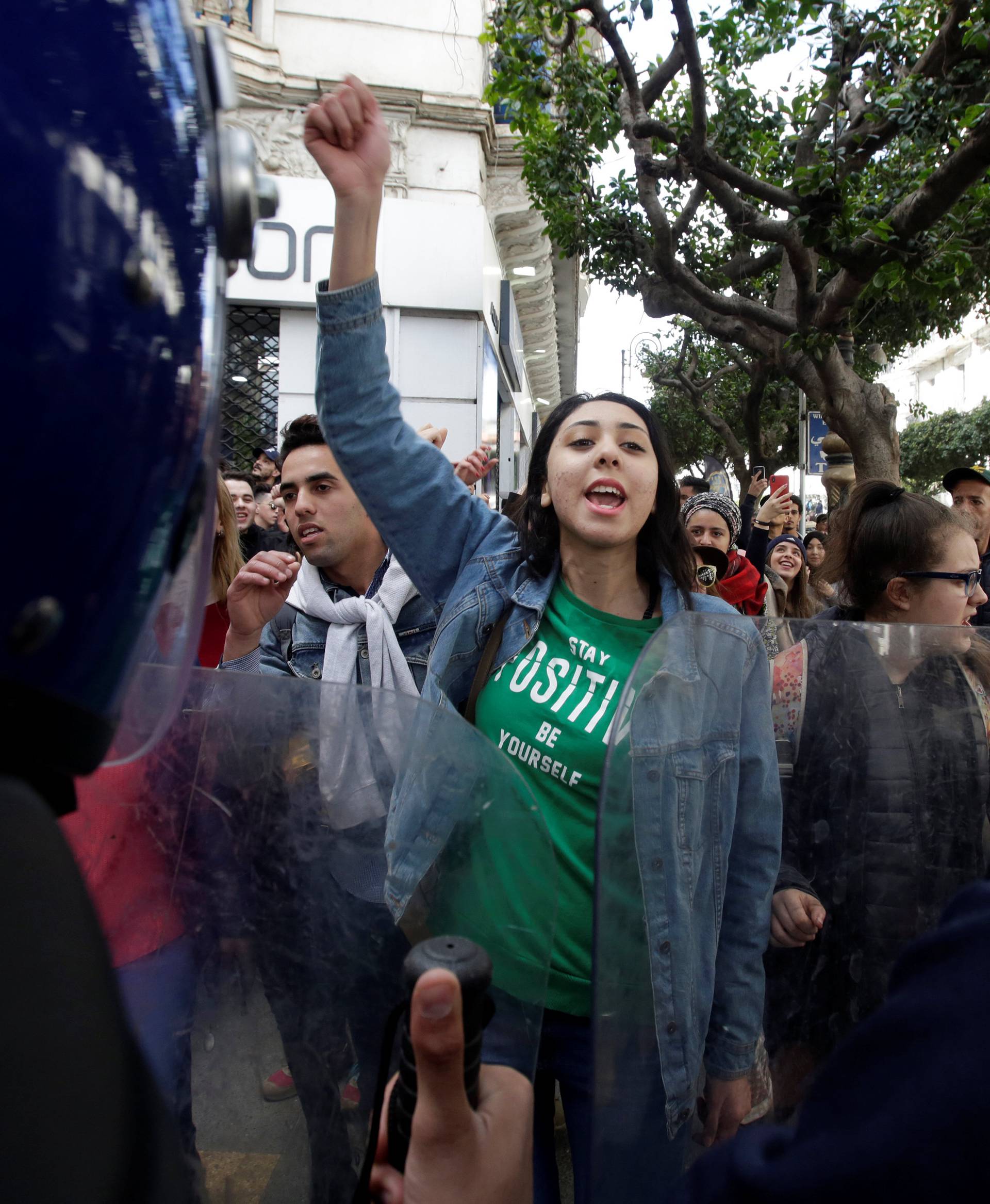 Police stand guard as students protest against President Abdelaziz Bouteflika's plan to extend his 20-year rule by seeking a fifth term in Algiers