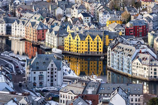 Sailing ships and art nouveau houses in the town of Alesund in Norway