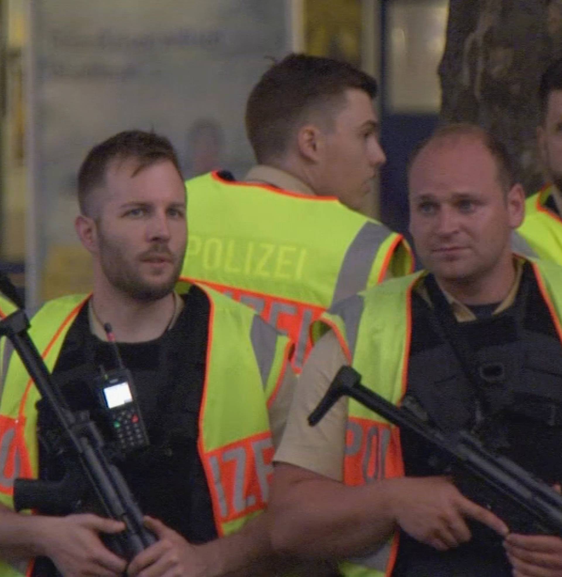 Police officers stand guard outside the main train station following shooting rampage at shopping mall in Munich