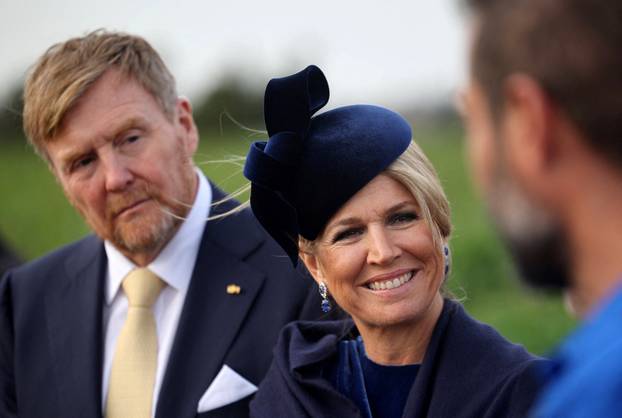 Dutch King Willem-Alexander and Queen Maxima speak with farmers during a visit in a potato field in Xylofagou