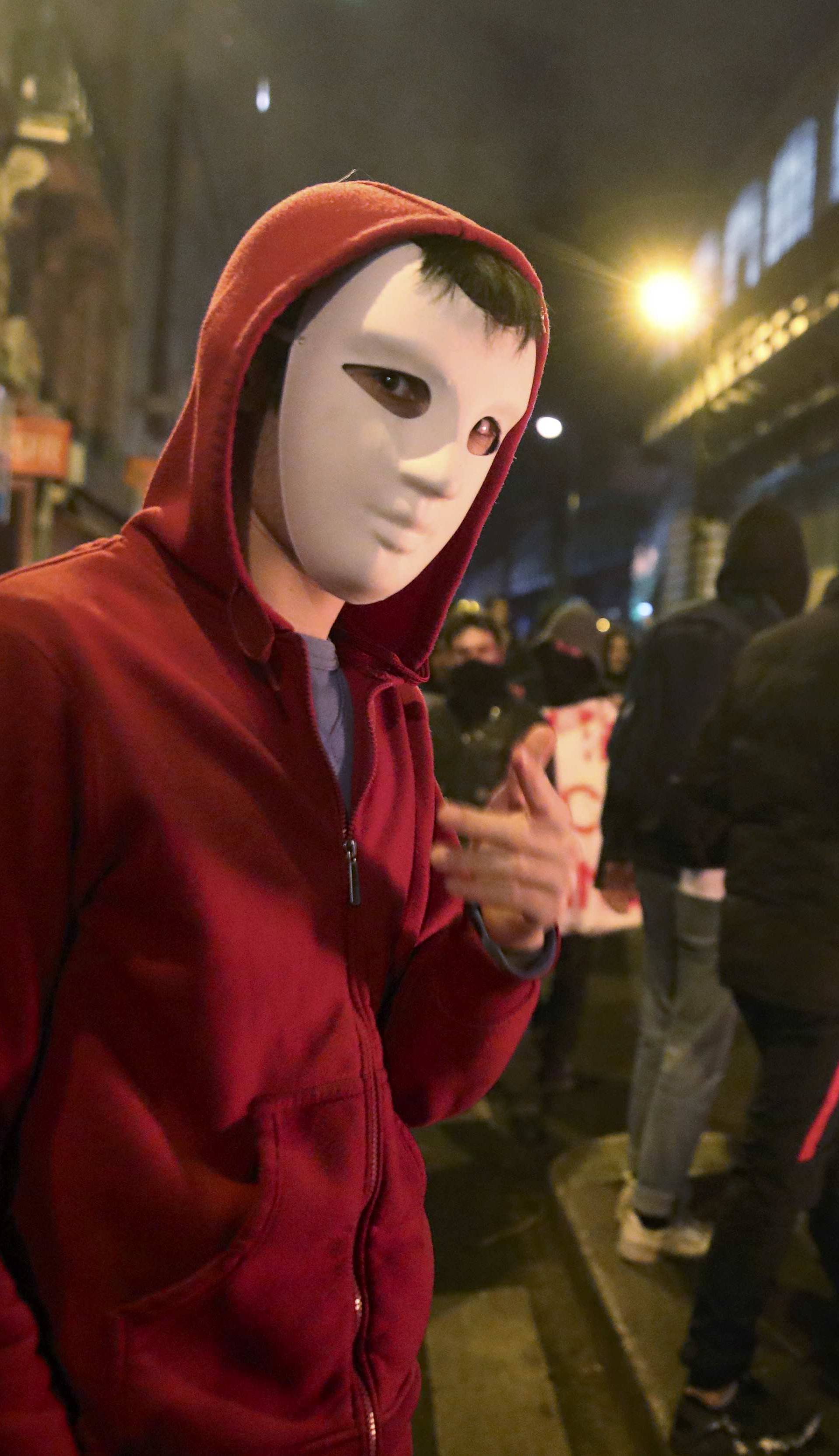 A man wearing a Guy Fawkes mask attends a protest against police brutality after a young black man, 22-year-old youth worker named Theo, was severly injured during his arrest earlier this month in Bobigny, as people gather at a demonstration in Paris 