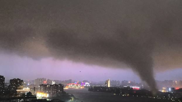 A tornado moves through an area amid lightning and strong winds, in Ezhou