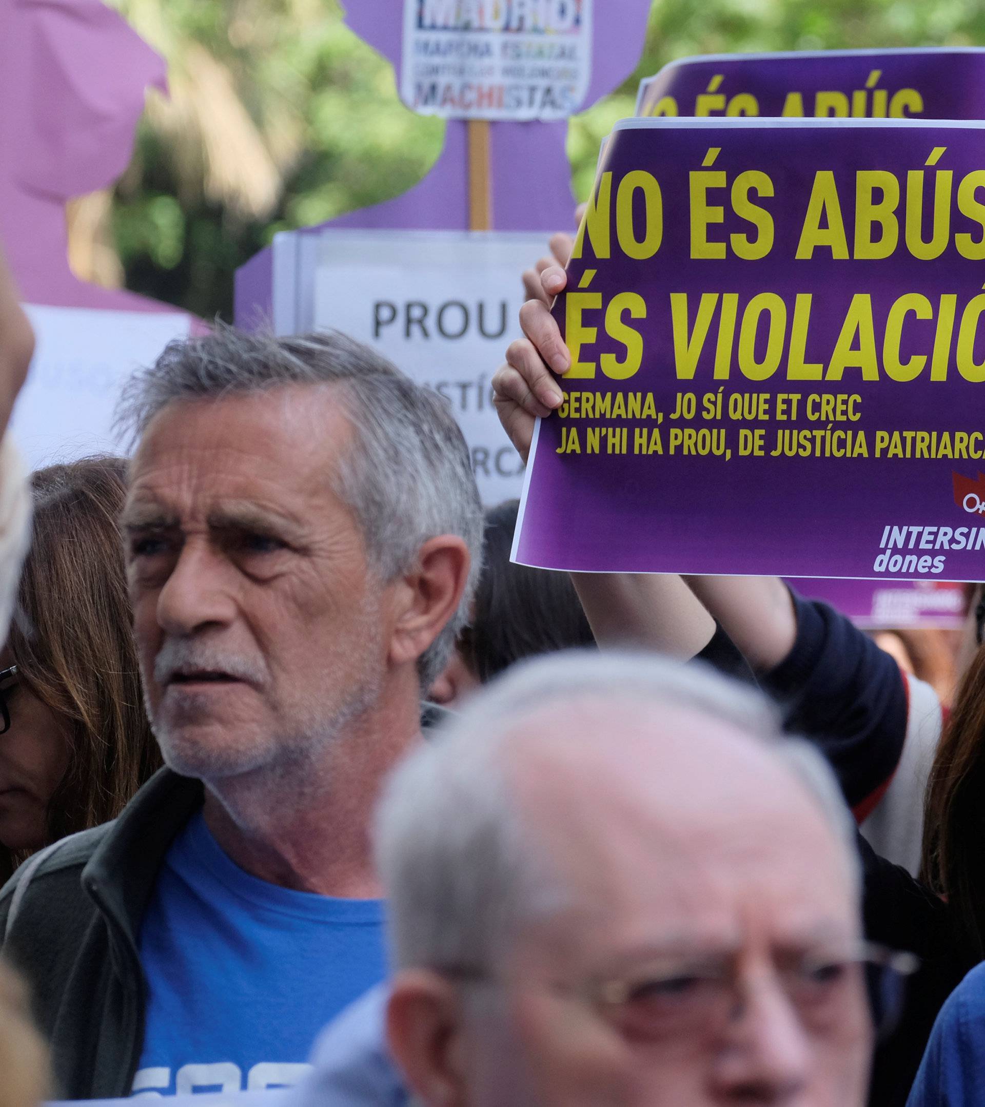 People shout slogans during a protest outside the City of Justice in Valencia