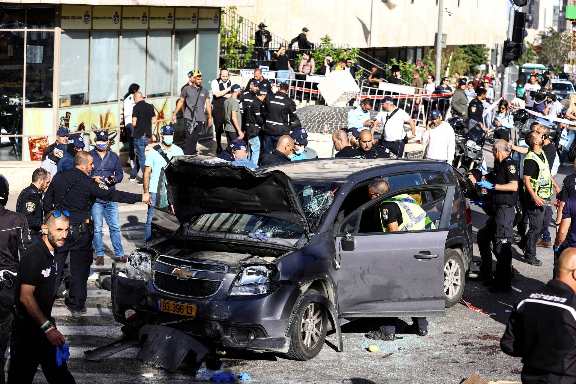 Israeli security forces and rescue workers work at the scene following an incident by Jerusalem's main market