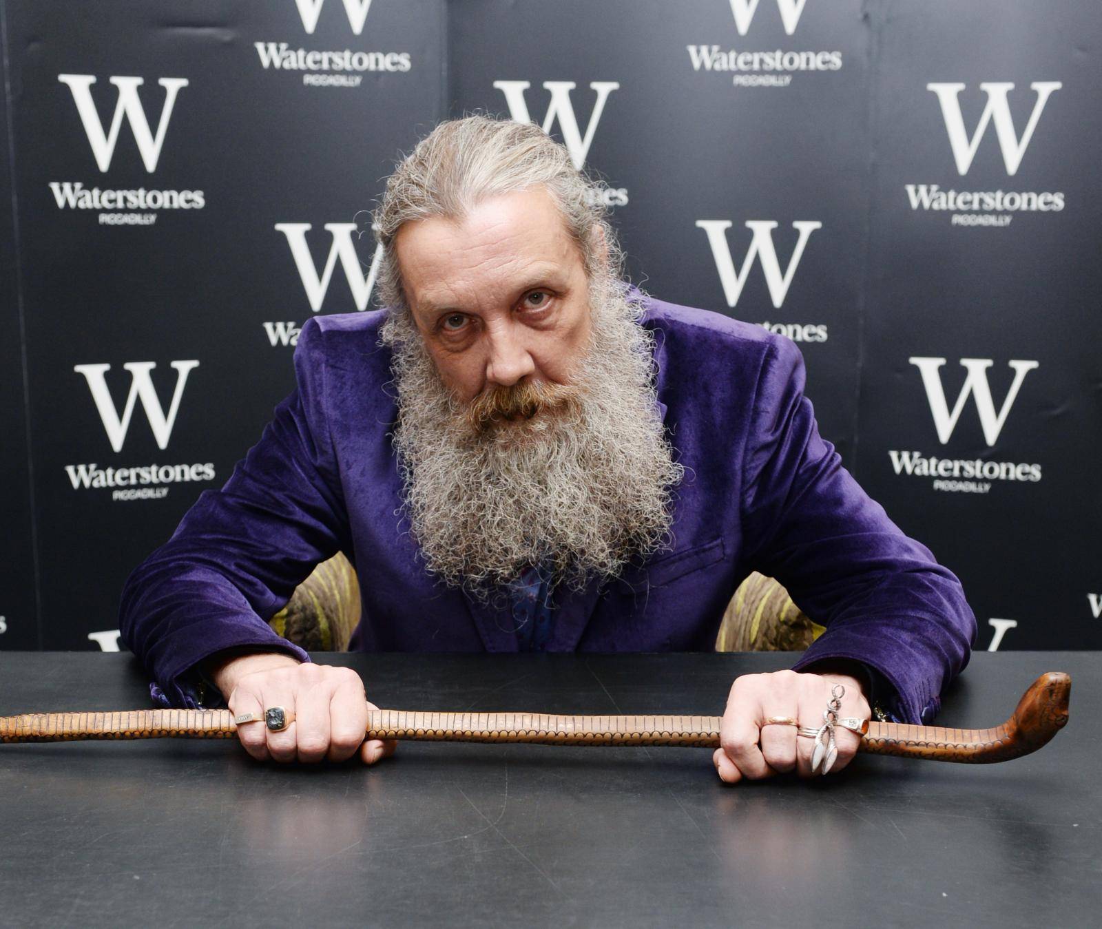 Alan Moore signs copies of his book 'Fashion Beast'