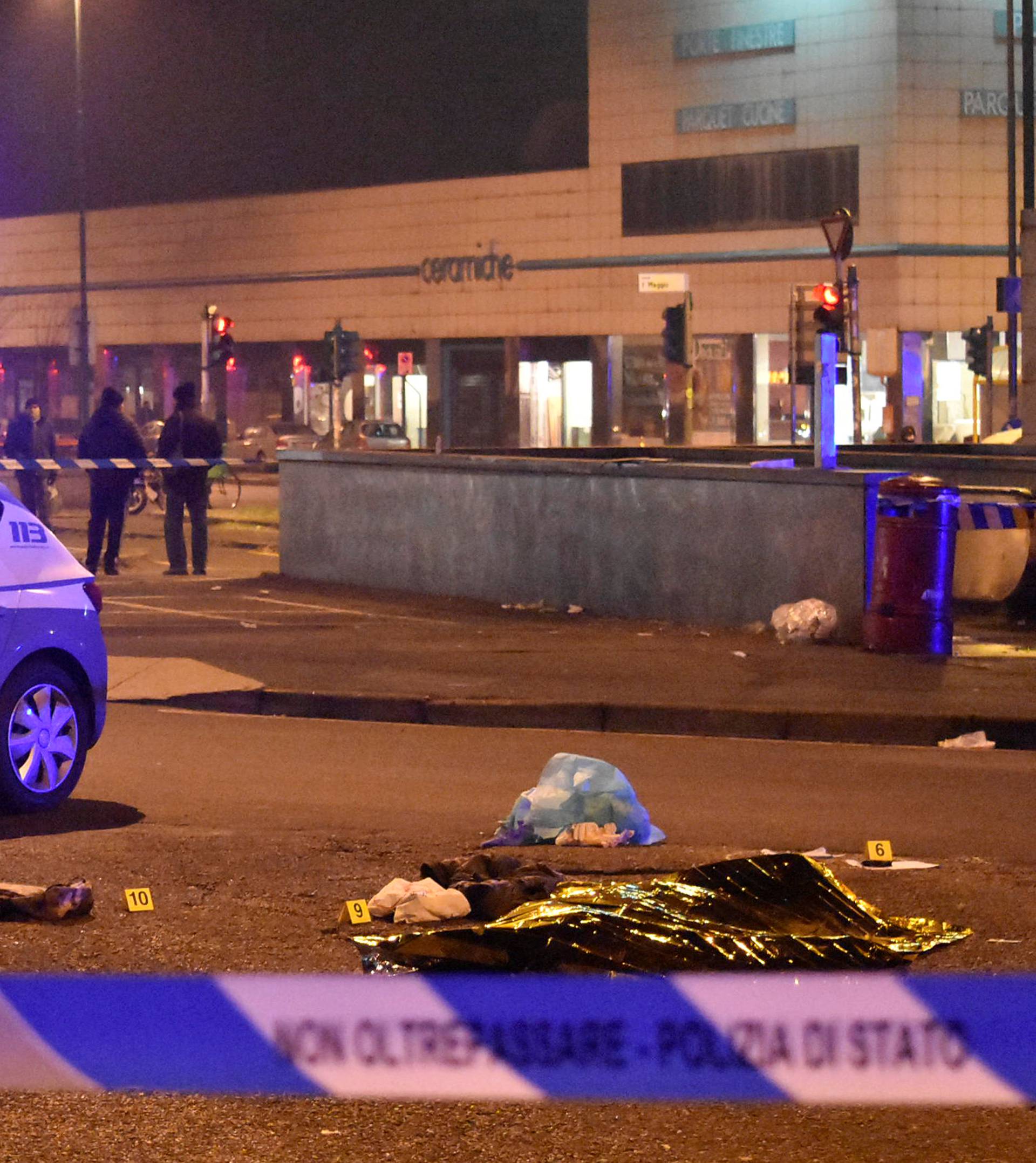 The body of Anis Amri, the suspect in the Berlin Christmas market truck attack, is seen covered by a thermal blanket in a suburb of the northern Italian city of Milan