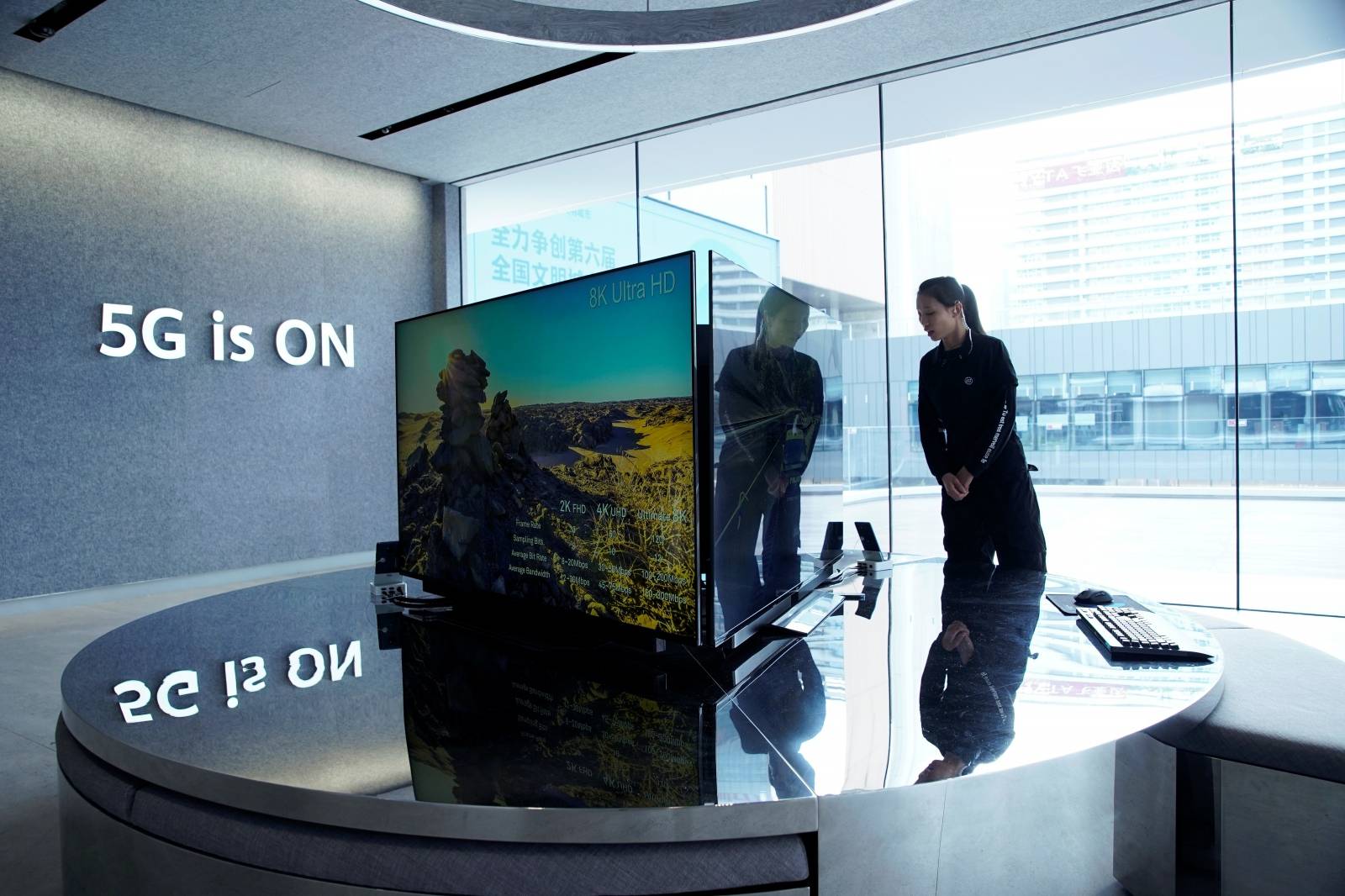 A woman stands in Huawei's first global flagship store in Shenzhen