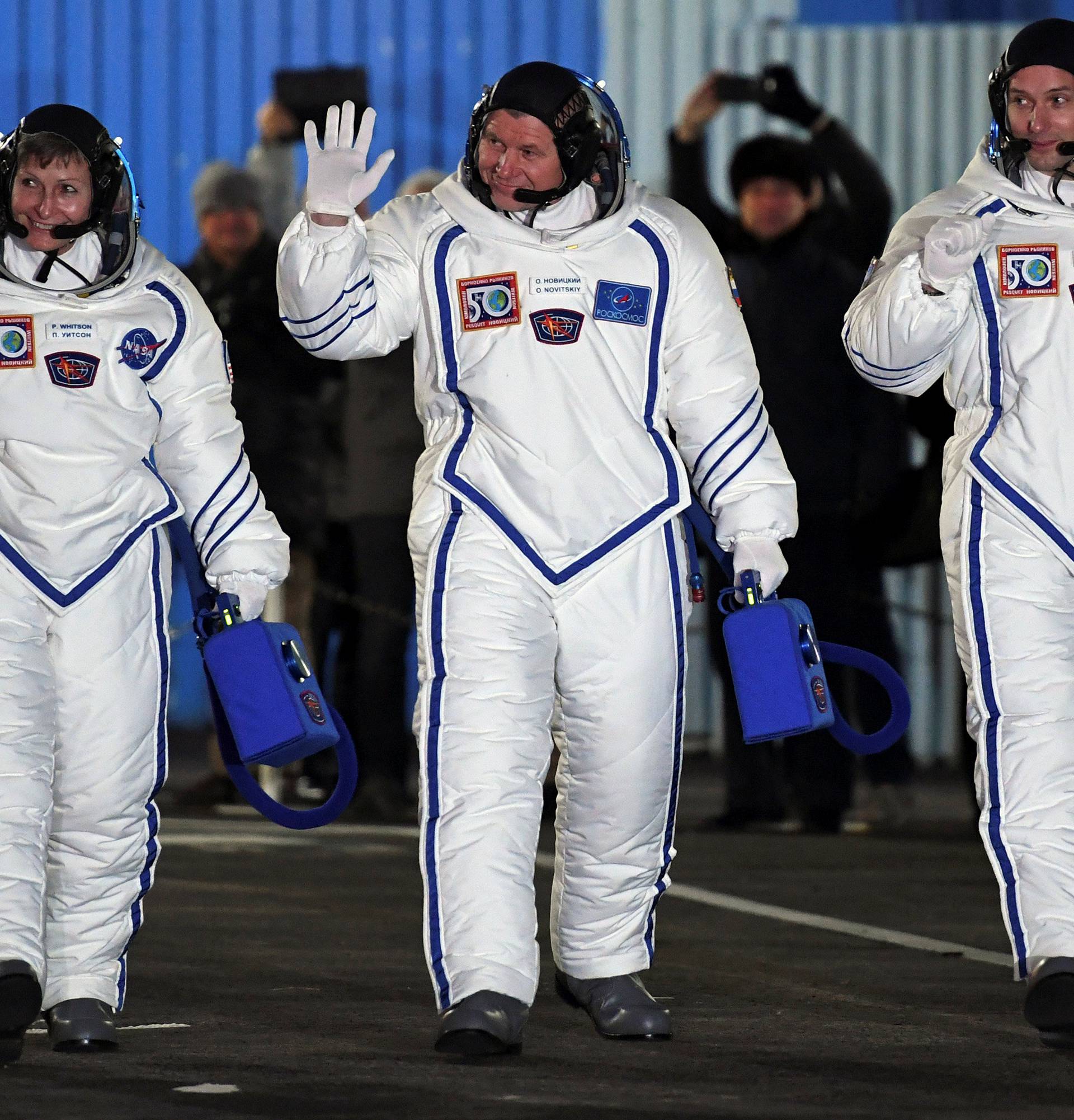 The International Space Station (ISS) crew members Peggy Whitson of the U.S., Oleg Novitskiy of Russia and Thomas Pesquet of France walk to board the Soyuz MS-03 spacecraft for the launch at the Baikonur cosmodrome