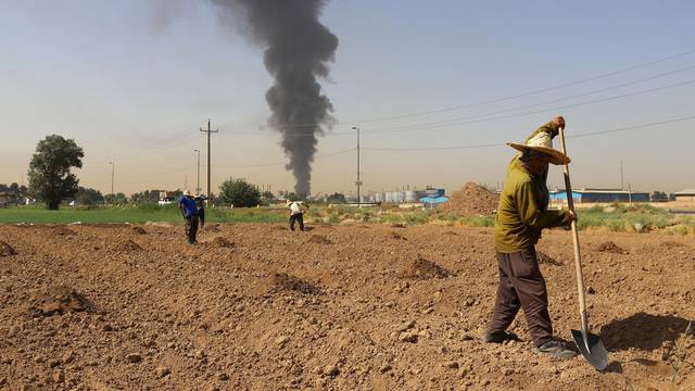 FILE PHOTO: Farmers work in a field in Iran