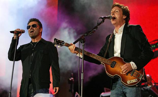 FILE PHOTO: British singers Paul McCartney and George Michael perform at the Live 8 concert in Hyde Park in London