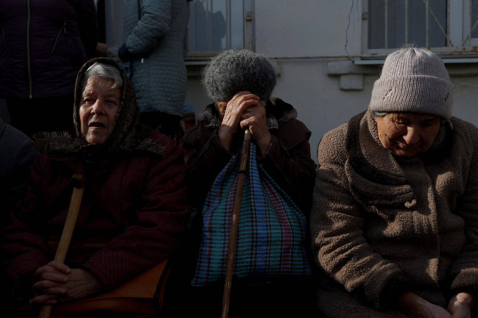 People queue to receive pensions and state aid, in Savyntsi