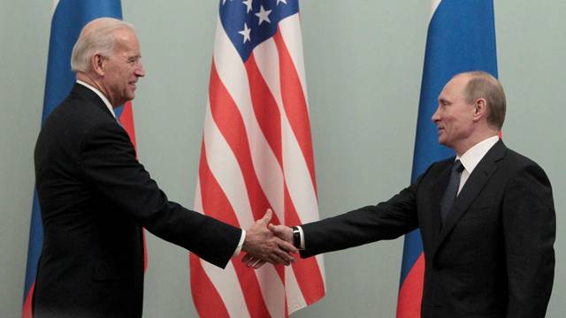 FILE PHOTO: Russian Prime Minister Putin shakes hands with U.S. Vice President Biden during their meeting in Moscow