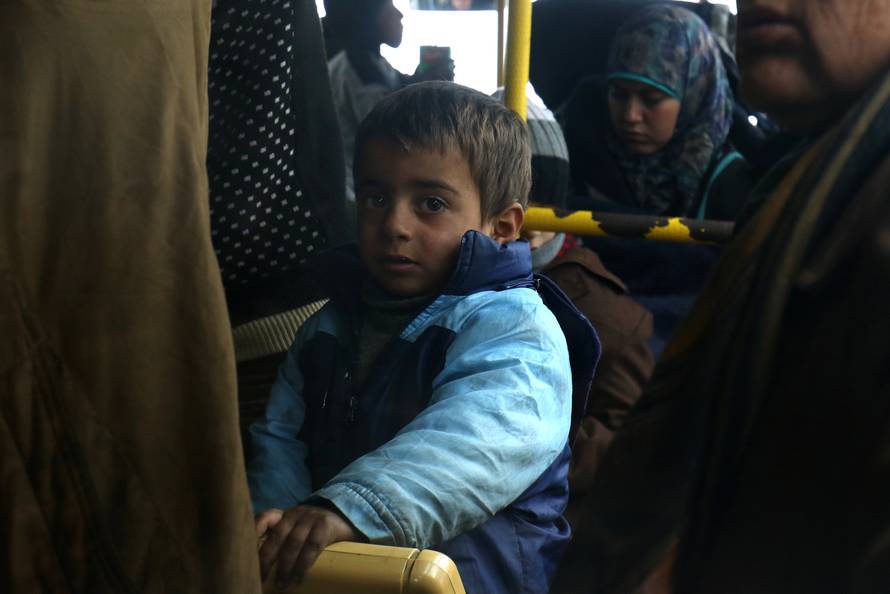 Evacuees from the Shi'ite Muslim villages of al-Foua and Kefraya ride a bus at insurgent-held al-Rashideen in Aleppo province