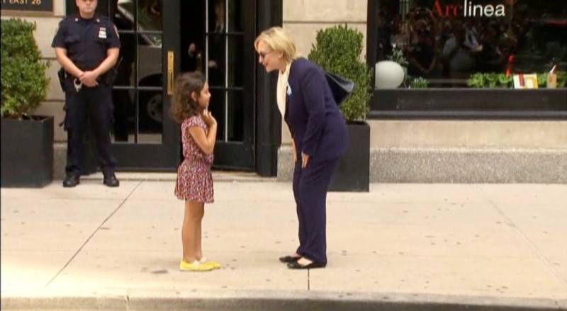 U.S. Democratic presidential nominee Hillary Clinton greets a girl on the sidewalk after leaving her daughter Chelsea's home in New York