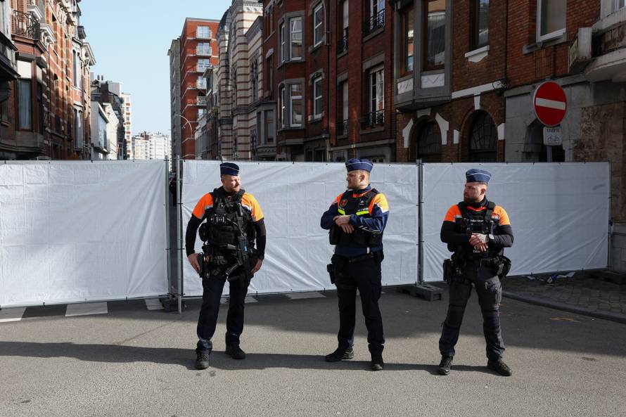 Police secure the site near a synagogue damaged by an explosion in Liege