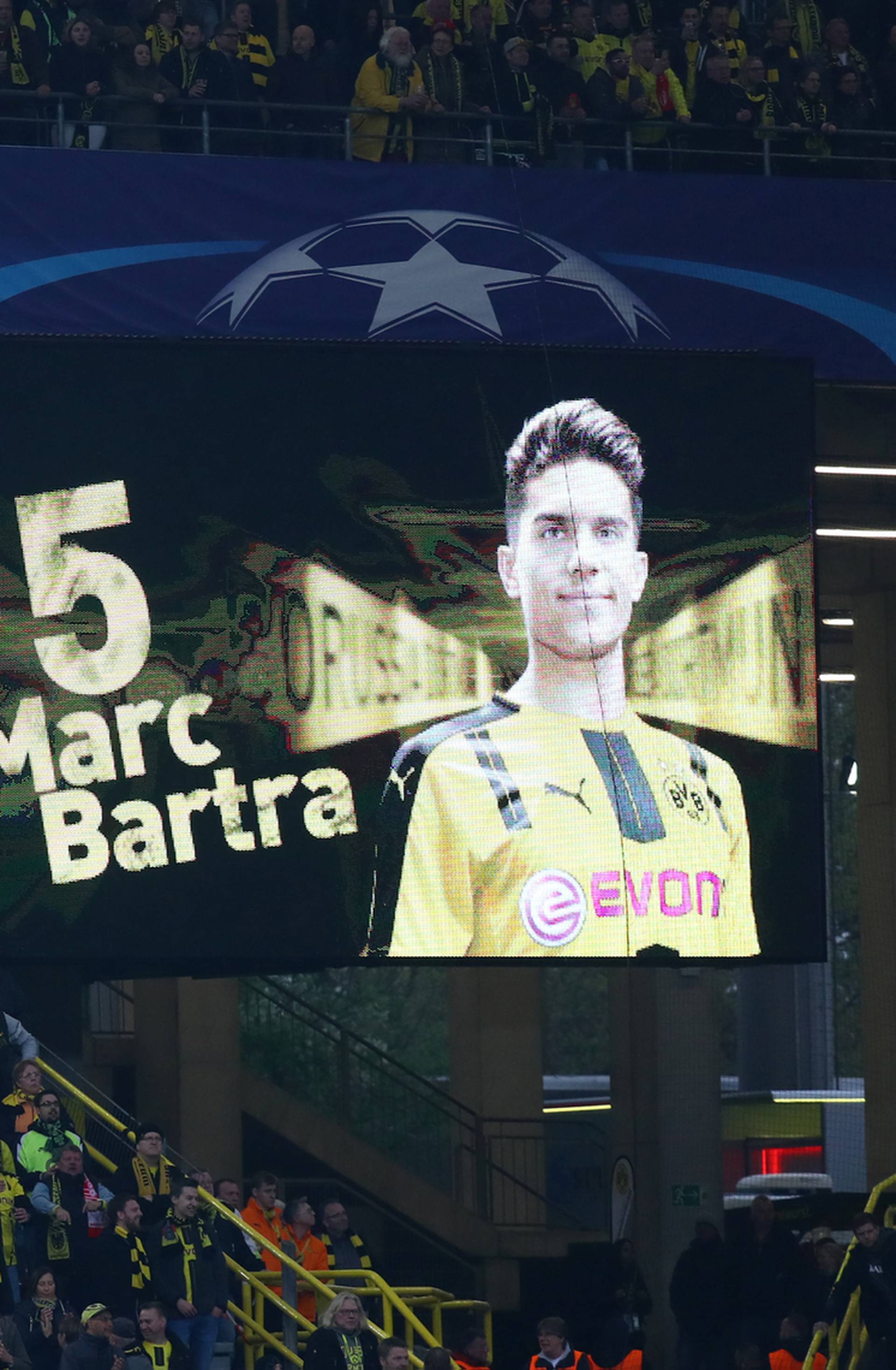 Borussia Dortmund fans look on as a message is displayed in support of Borussia Dortmund's Marc Bartra