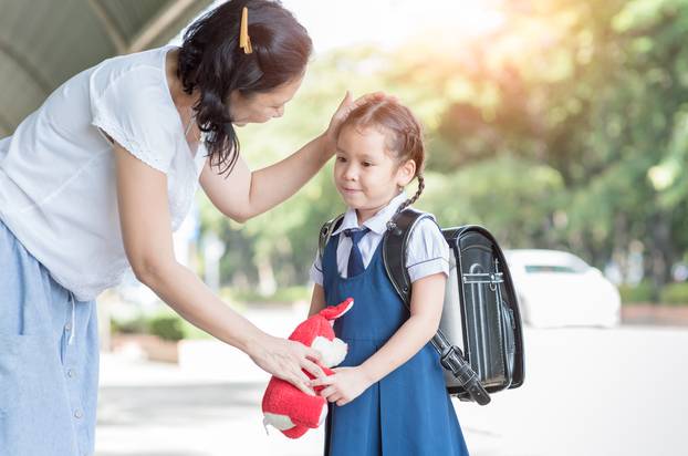 Mother,Standing,At,School,Holding,Hands,And,Teaching,Her,Daughter,