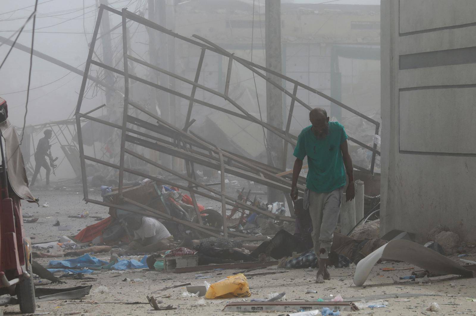 Injured civilians are aeen at the scene of an explosion near the education ministry building along K5 street in Mogadishu
