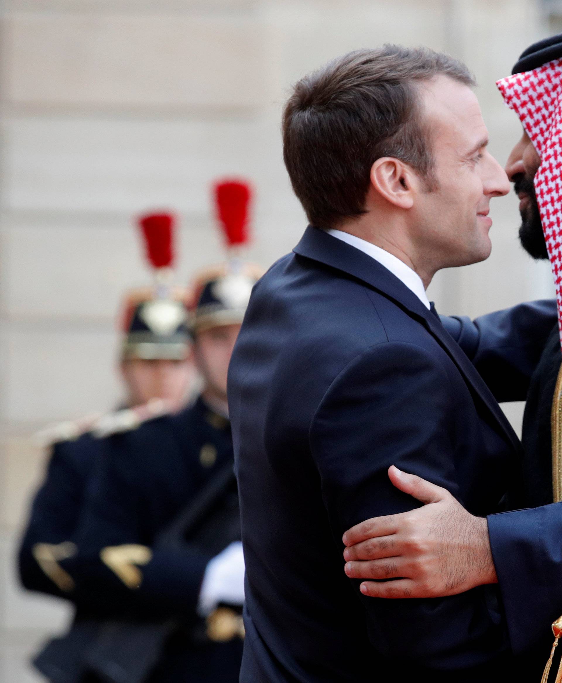 French President Emmanuel Macron welcomes Saudi Arabia's Crown Prince Mohammed bin Salman as he arrives at the Elysee Palace in Paris