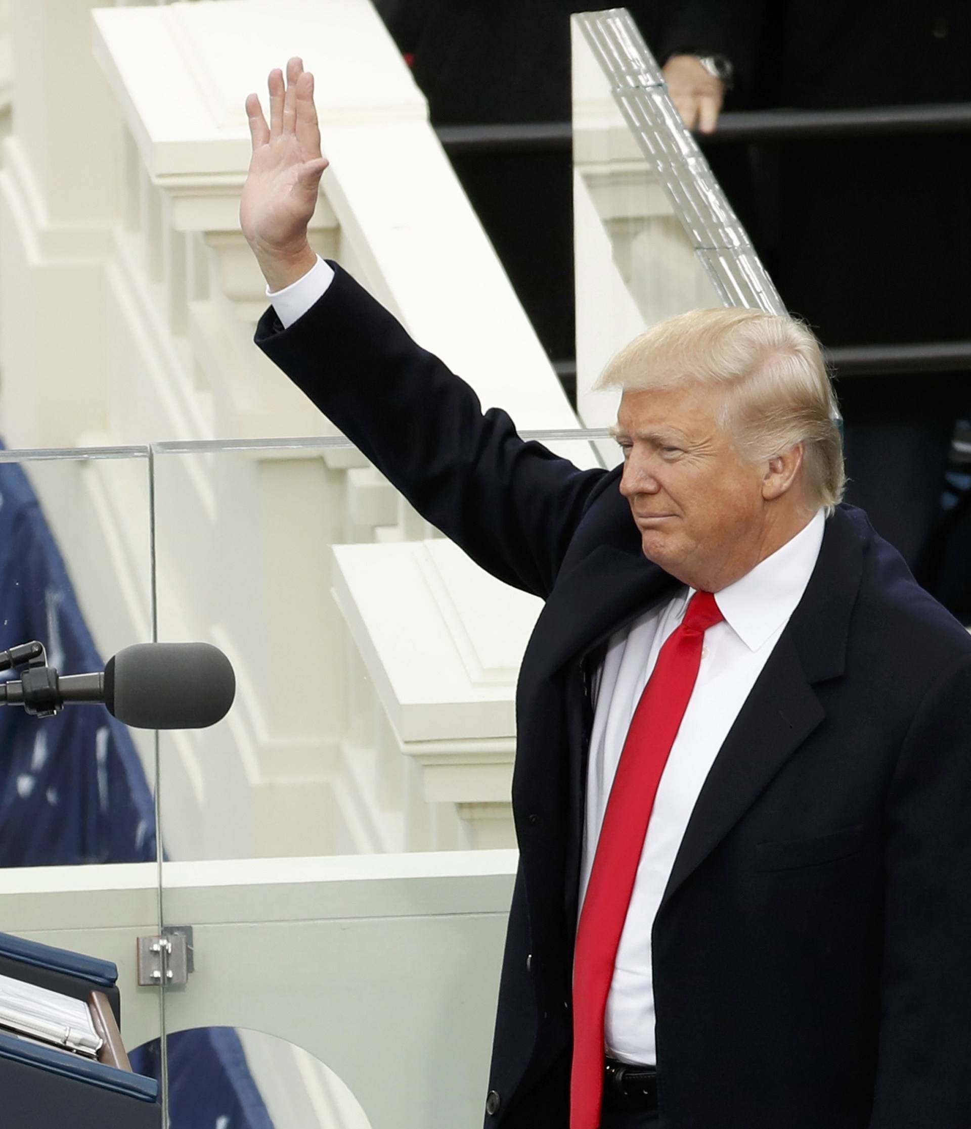 Donald Trump and his wife Melania wave to crowd after he was sworn in as the 45th president of the United States in Washington