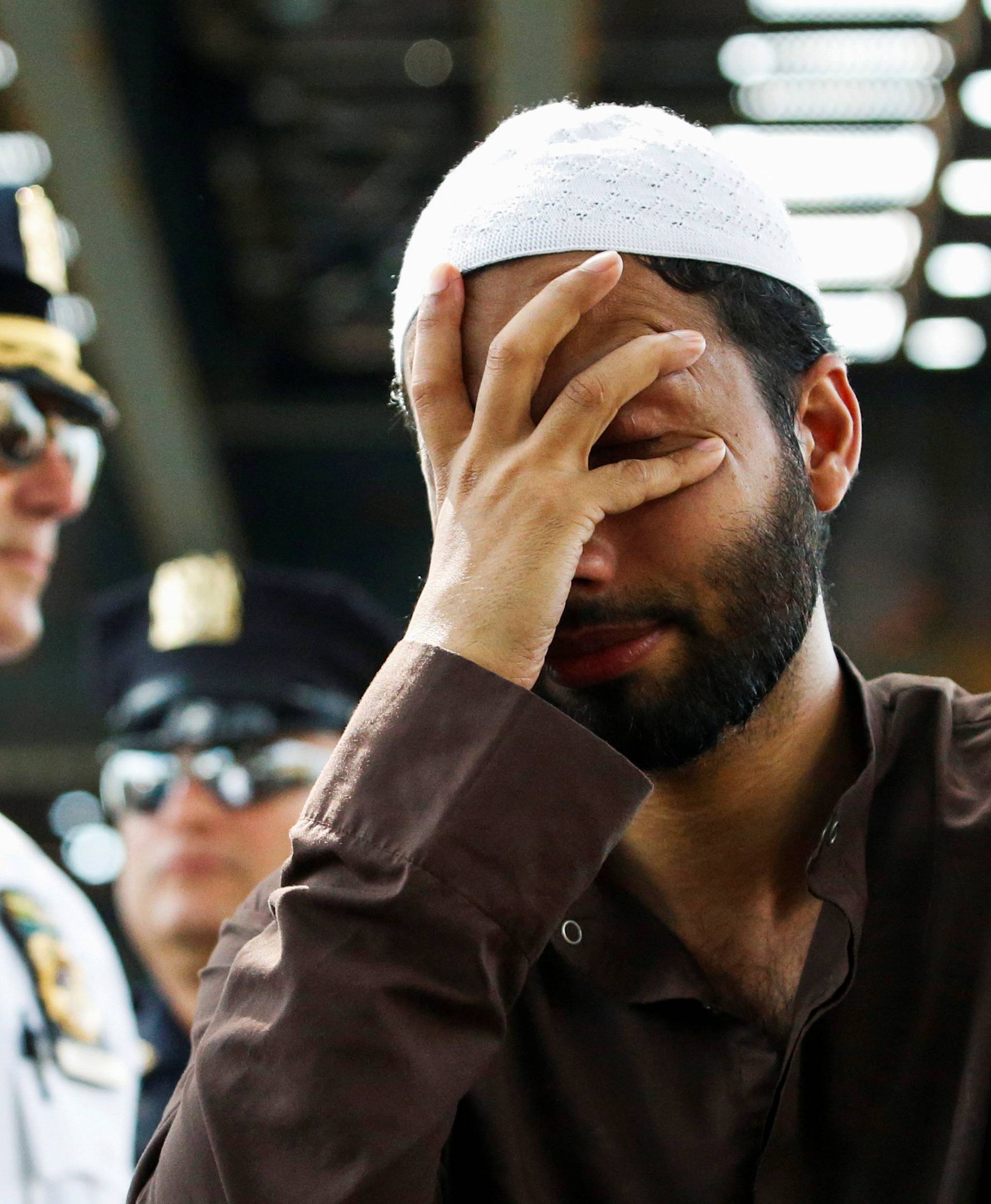 A man cries as community members take part in a protest to demand stop hate crime after the funeral service of Maulama Akonjee, and Uddin in the Queens borough of New York City
