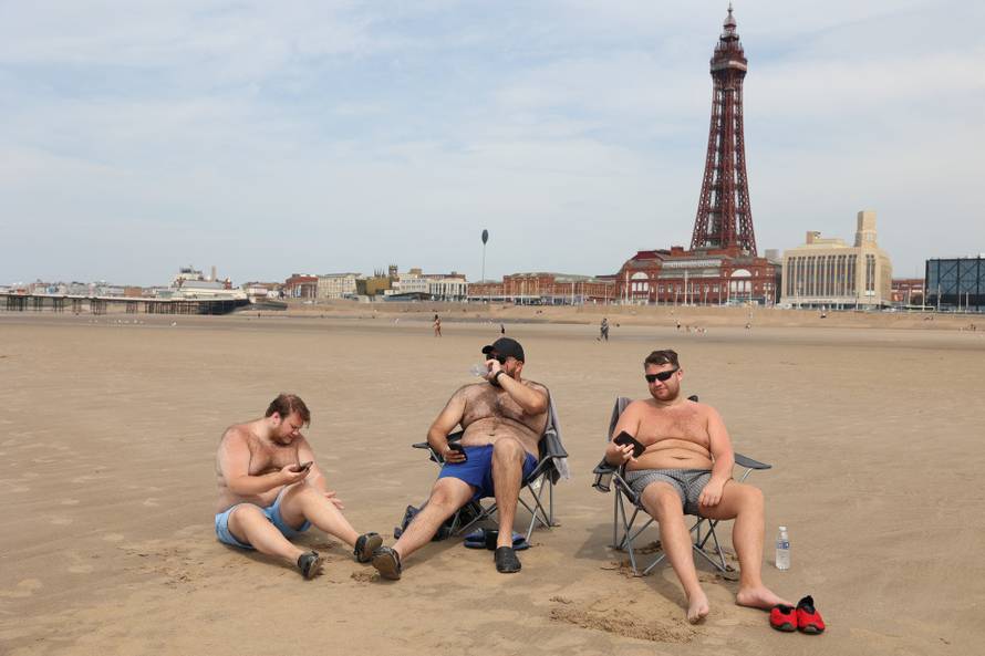 People relax on the beach on a hot day in Blackpool