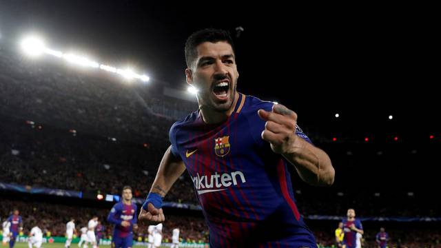 FILE PHOTO: Barcelona's Luis Suarez celebrates scoring their fourth goal in a 4-1 victory over Italy's AS Roma in the first leg of their Champions League quarter-final tie.