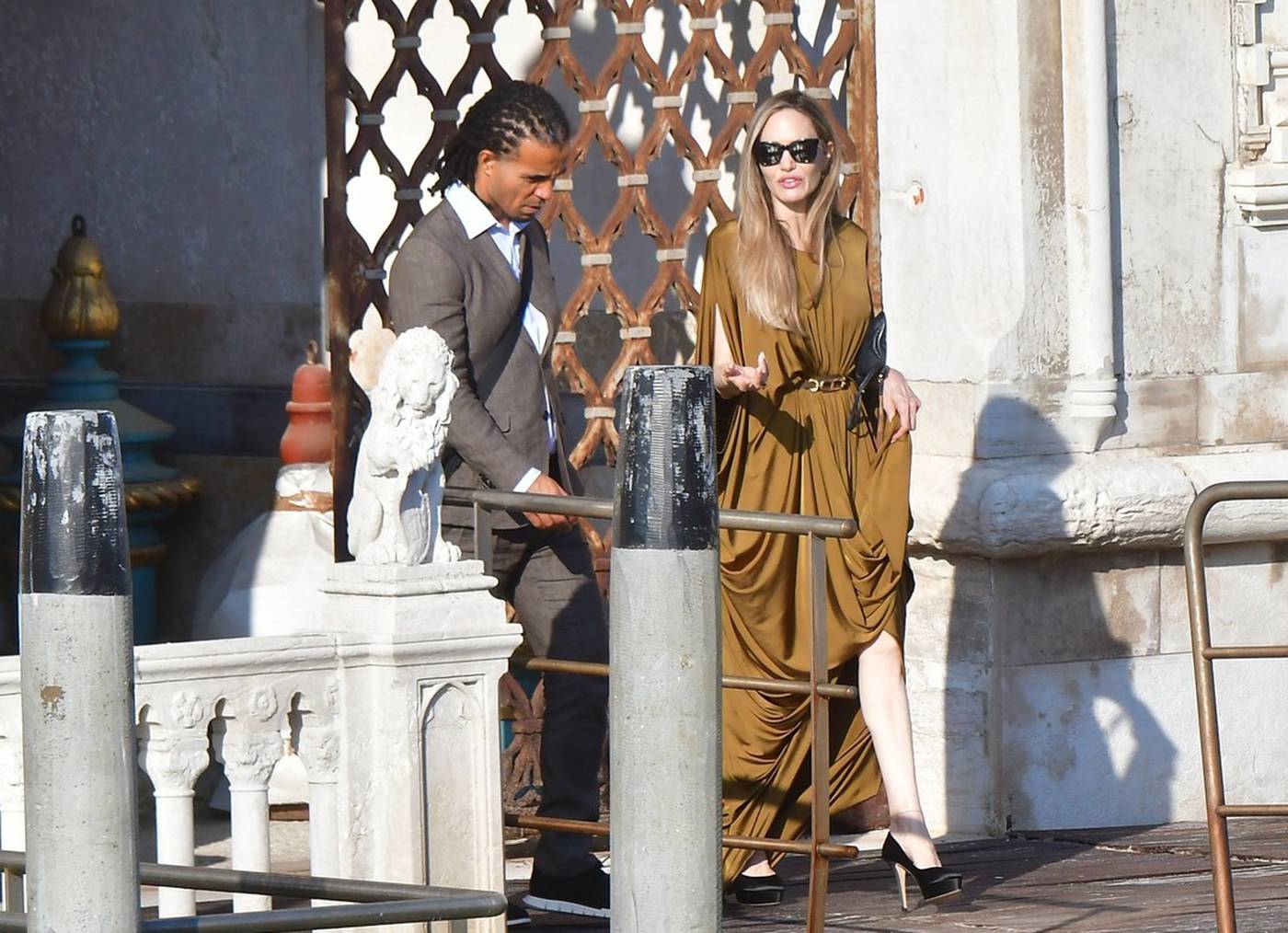 *EXCLUSIVE* American Actress Angelina Jolie looks glamorous rocking a Grecian dress while seen with rapper Akala as they are seen leaving the hotel to attend the the Maria premiere during the Venice Film Festival.