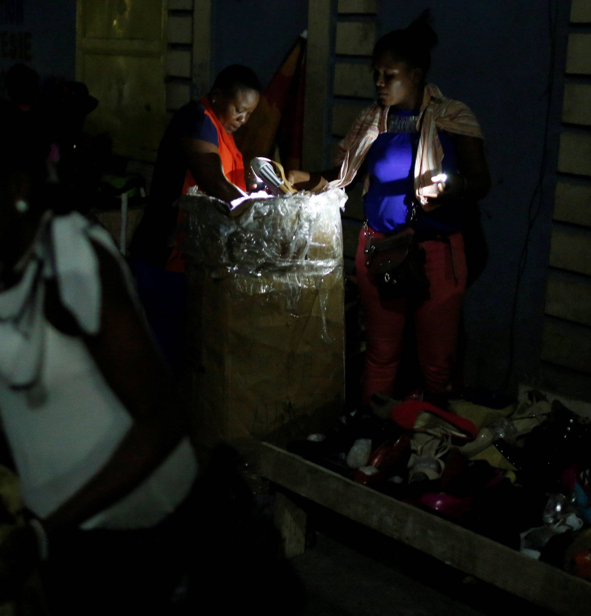 Vendors sell their goods on a street market while Hurricane Matthew approaches in Port-au-Prince, Haiti