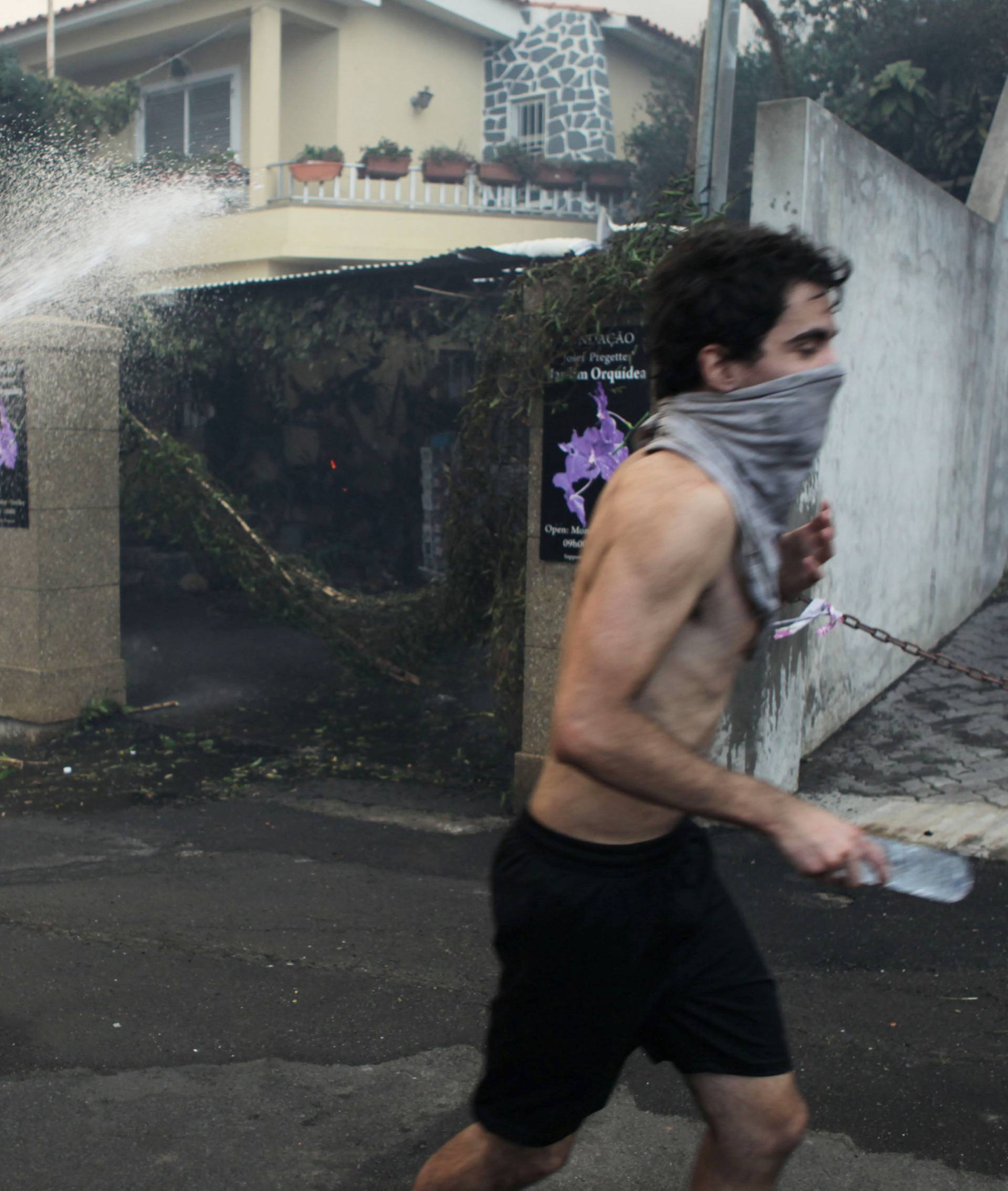 A man runs in Bom Sucesso during the wildfires at Funchal