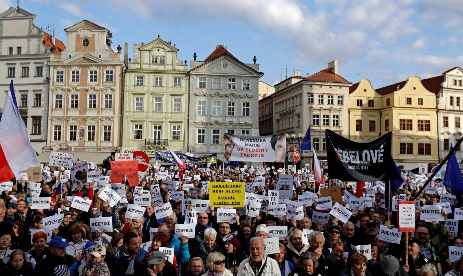 FILE PHOTO: Demonstrators hold banners during a protest rally demanding resignation of Czech Prime Minister Andrej Babis in Prague