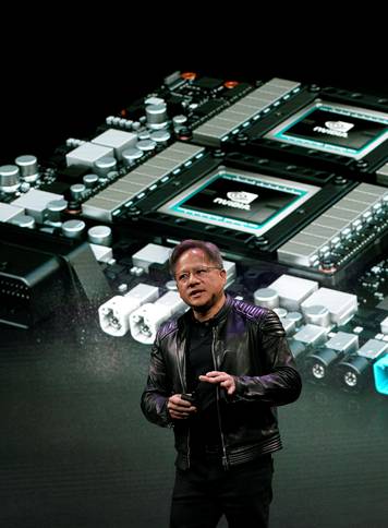 Jensen Huang, CEO of Nvidia, shows the Drive Pegasus robotaxi AI computer at his keynote address at CES in Las Vegas