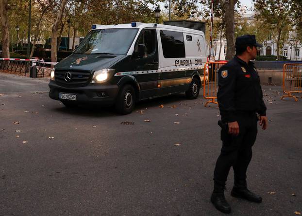 A van carrying members of the dismissed Catalan cabinet leaves a garage of Spain