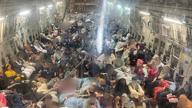 Passengers sit inside a Royal Air Force C-17