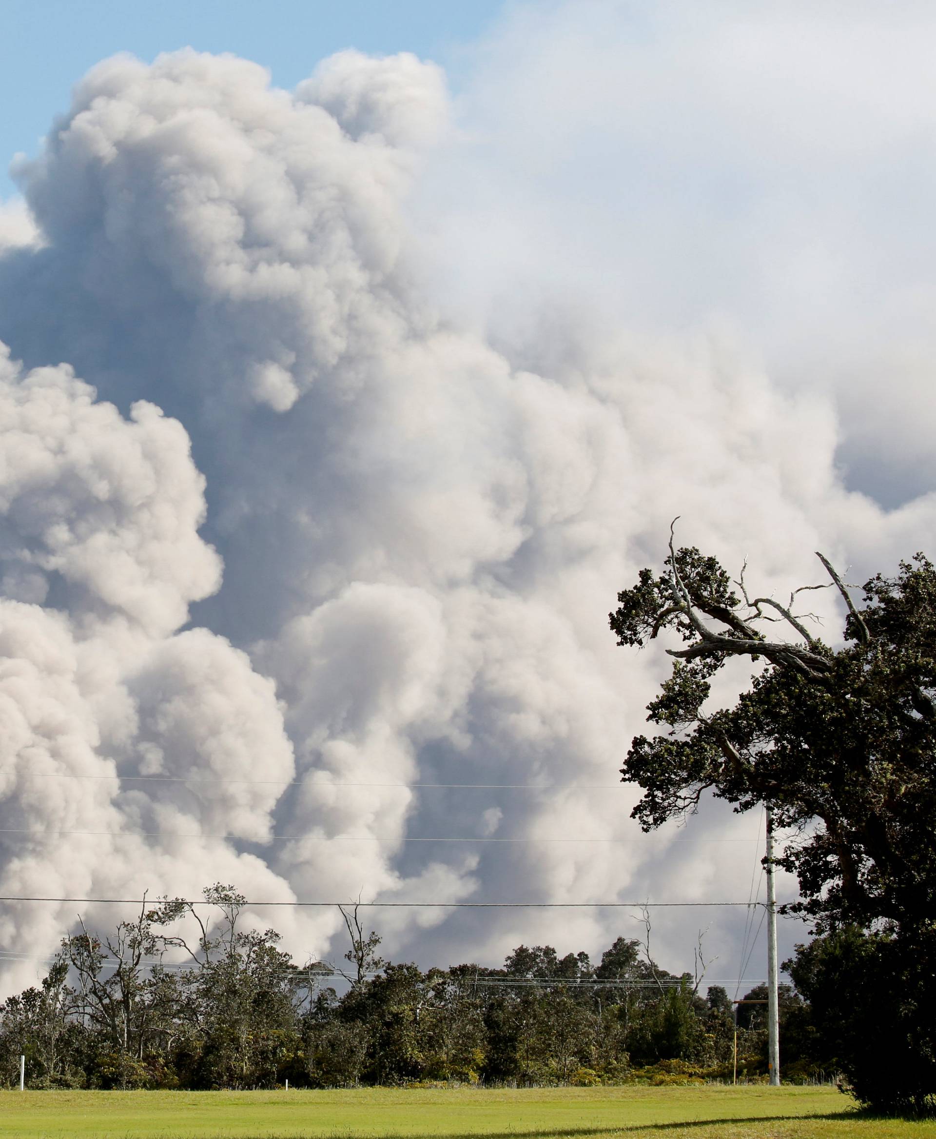 Ash erupts from Halemaumau Crater near the community of Volcano