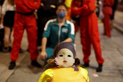 People wear Netflix series 'Squid Game' costumes celebrating Halloween, in Hong Kong