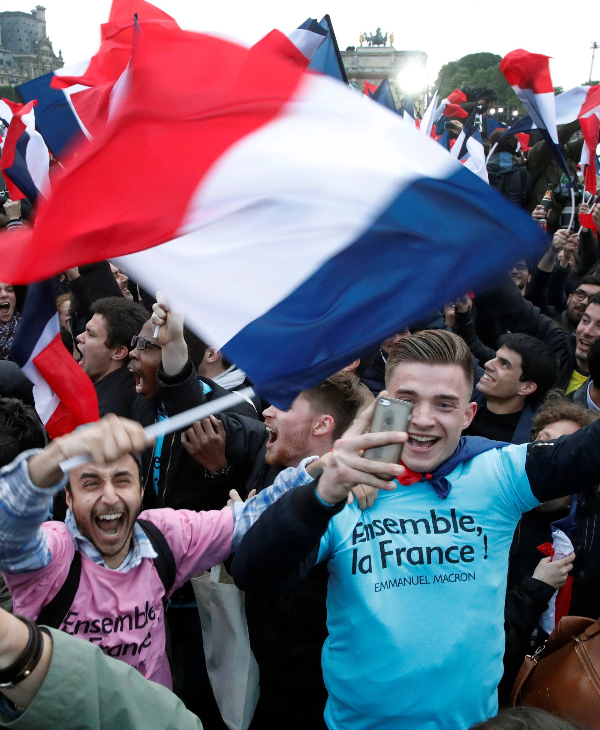 Supporters of President Elect Emmanuel Macron celebrate near the Louvre museum after results were announced in the second round vote of the 2017 French presidential elections, in Paris